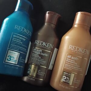 Redken shampoo trio in blue, brown, and bronze bottles